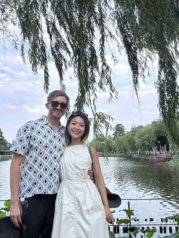 Michael in a short-sleeve button-down, Lina in a simple white dress