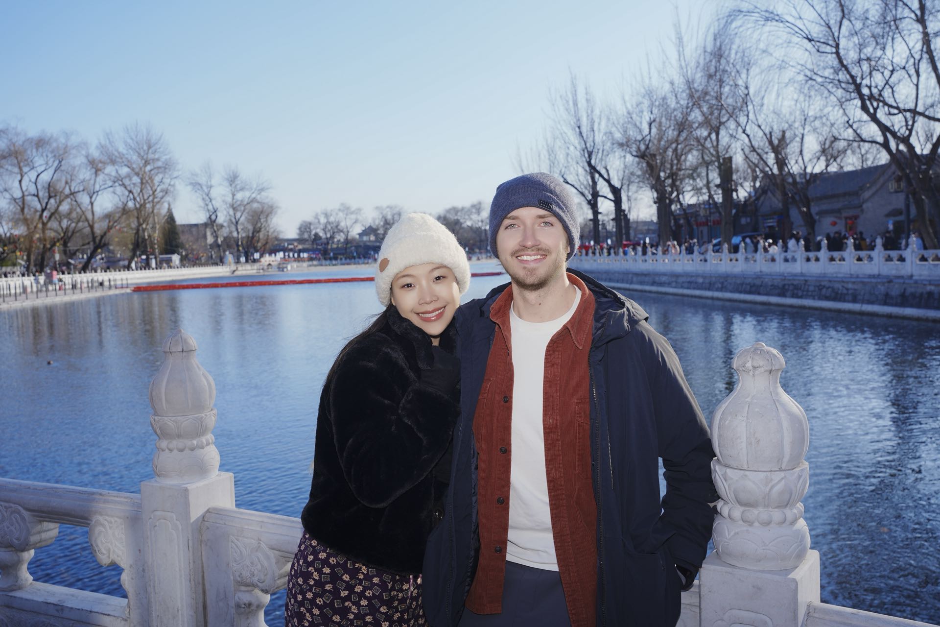Michael and Lina by a frozen lake in winter Beijing