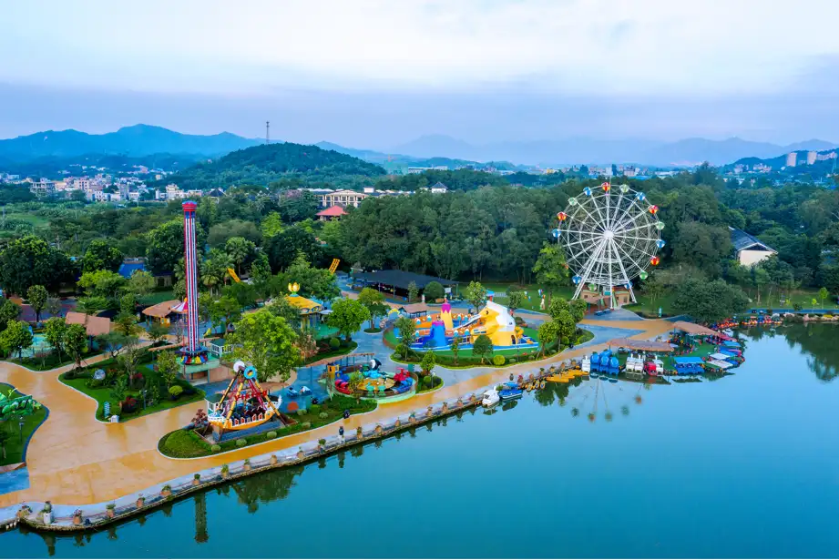 Aerial view of Shampoola Resort — theme park, Ferris wheel and lake ringed by forested hills